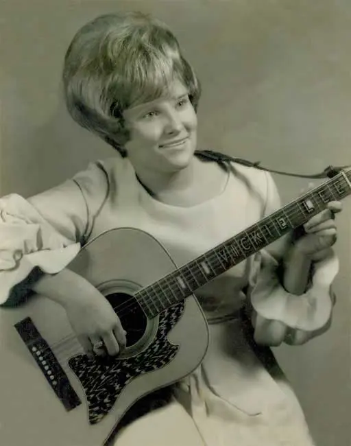 Vicki Lee performing with her guitar, early in her career